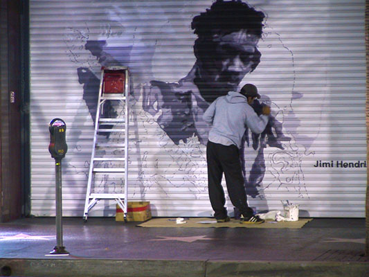 Artist painting the Jimmy Hendrix Door